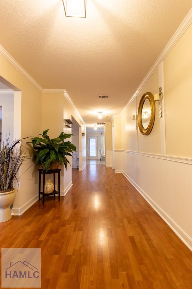 302 Largo Ct, Hinesville, GA 31313 - hall with visible vents, ornamental molding, a textured ceiling, and wood finished floors
