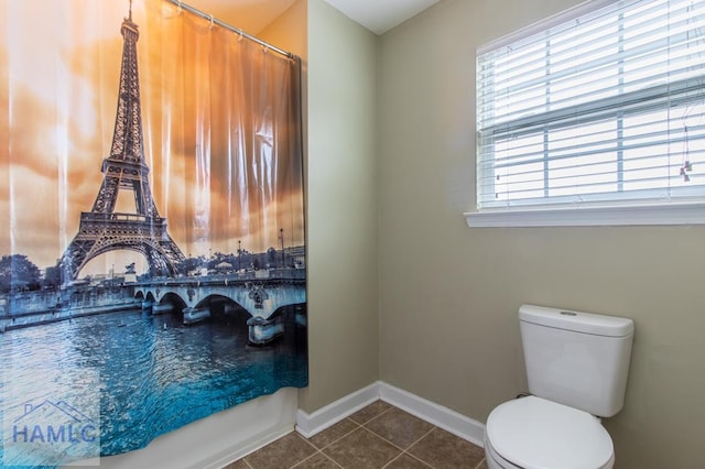 full bathroom featuring tile patterned flooring, toilet, and baseboards