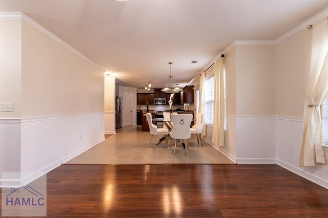 dining room featuring baseboards, crown molding, visible vents, and dark wood-type flooring