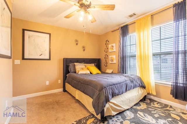 bedroom featuring baseboards, multiple windows, and visible vents