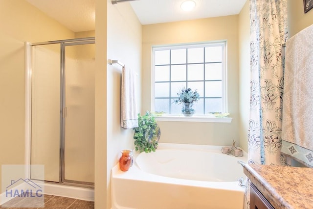 full bath featuring a stall shower, vanity, and a bath