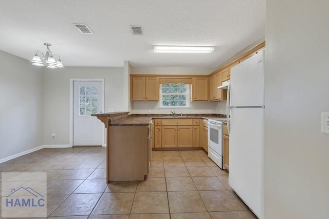 kitchen featuring a wealth of natural light, decorative light fixtures, sink, light brown cabinets, and white appliances