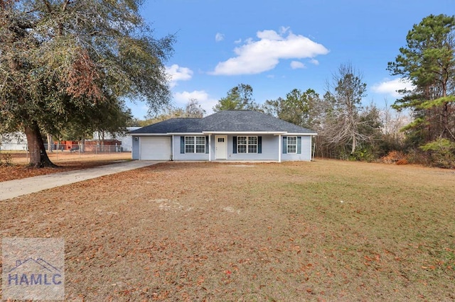 ranch-style house featuring a garage and a front lawn