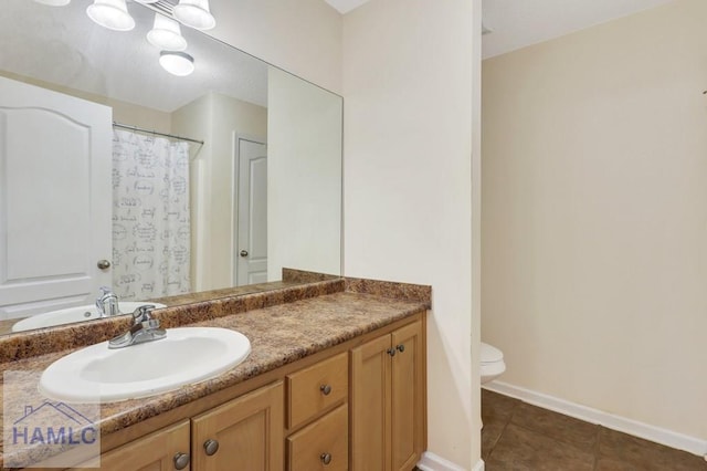 bathroom featuring tile patterned floors, toilet, and vanity