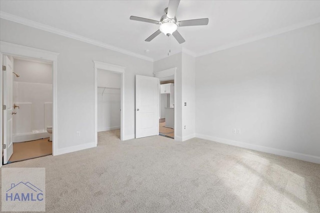 unfurnished bedroom featuring crown molding, light colored carpet, and baseboards