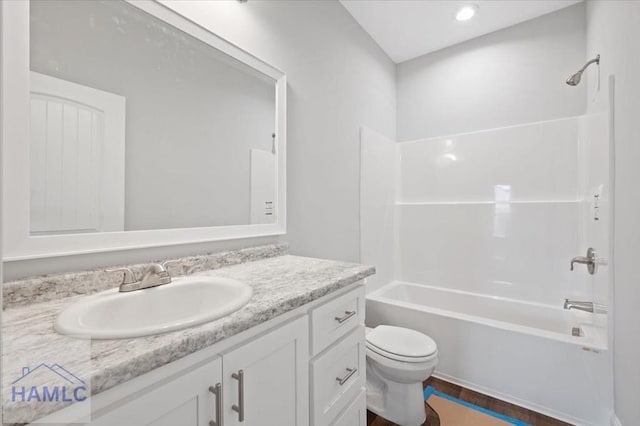 bathroom featuring toilet, vanity, and shower / tub combination