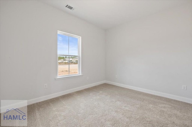 spare room with visible vents, baseboards, and carpet floors