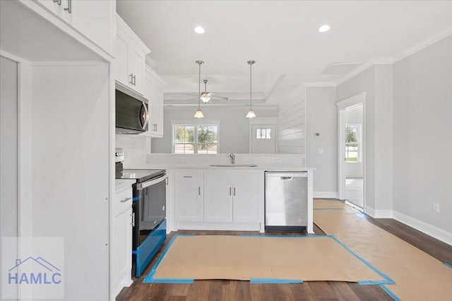 kitchen with dark wood-style flooring, stainless steel appliances, light countertops, and a sink