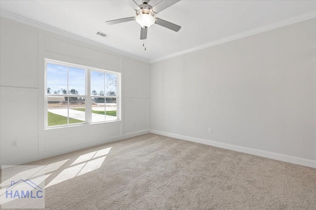 empty room with visible vents, ornamental molding, a ceiling fan, baseboards, and light colored carpet