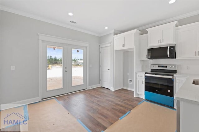 kitchen featuring wood finished floors, white cabinetry, stainless steel appliances, french doors, and crown molding