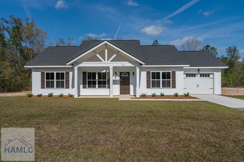 single story home featuring a garage and a front lawn