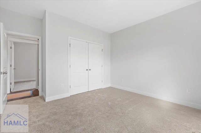 unfurnished bedroom featuring a closet, carpet flooring, and baseboards