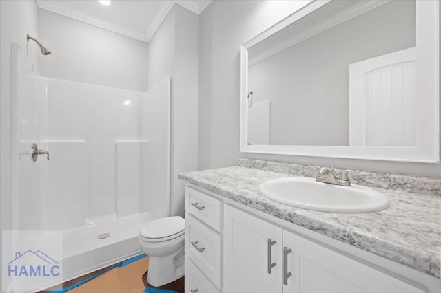 bathroom featuring a shower stall, toilet, vanity, and ornamental molding