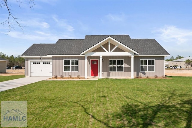 view of front of home featuring an attached garage, driveway, and a front lawn