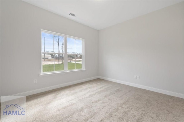 unfurnished room featuring baseboards, carpet floors, and visible vents