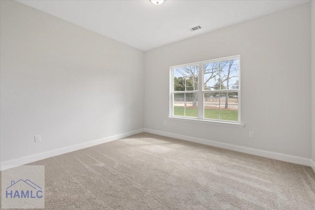 carpeted spare room with baseboards and visible vents