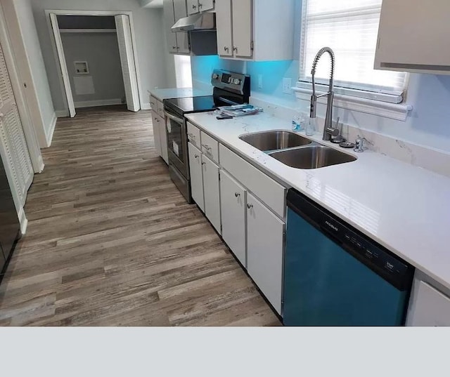 kitchen featuring white cabinetry, sink, stainless steel appliances, and light hardwood / wood-style flooring