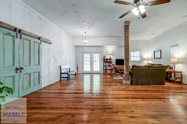 410 Green Morgan School Rd, Clyo, GA 31303 - living room featuring hardwood / wood-style flooring, french doors, a barn door, a ceiling fan, and ornamental molding
