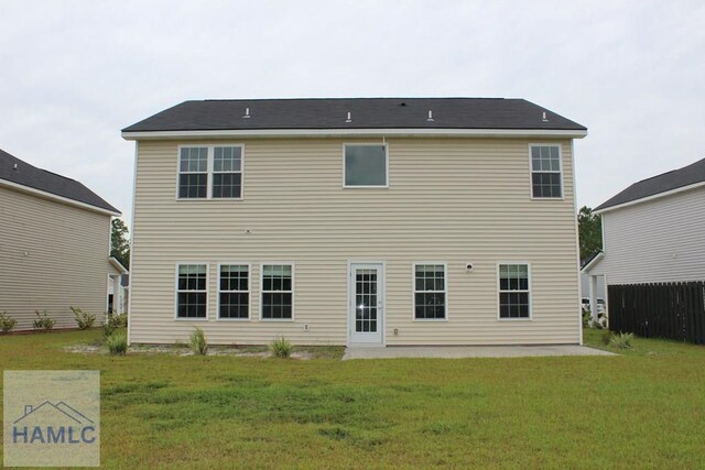 rear view of house with a yard