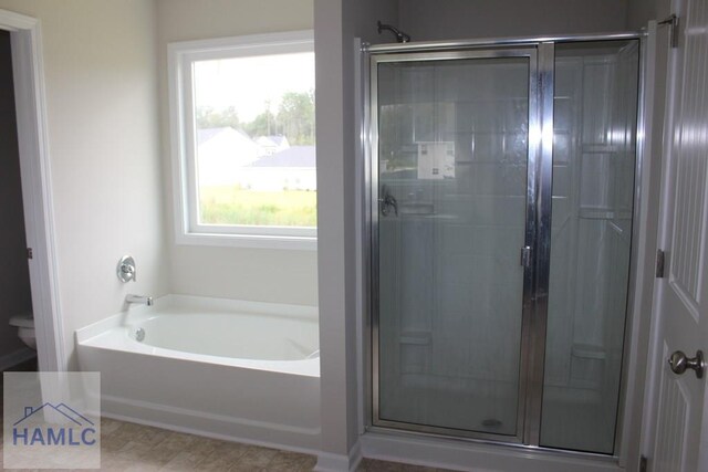 bathroom with separate shower and tub and toilet