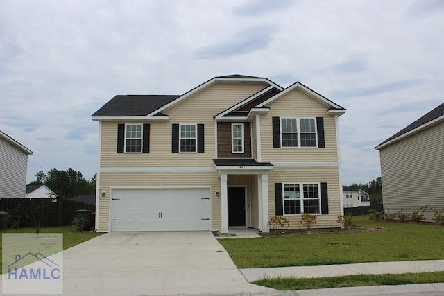 view of front of home featuring a front lawn and a garage