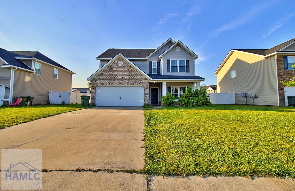 view of front of property with a garage and a front yard