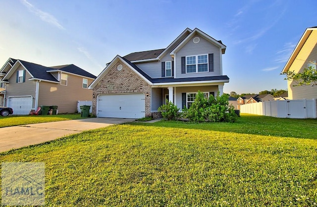 front of property featuring covered porch, a garage, and a front lawn