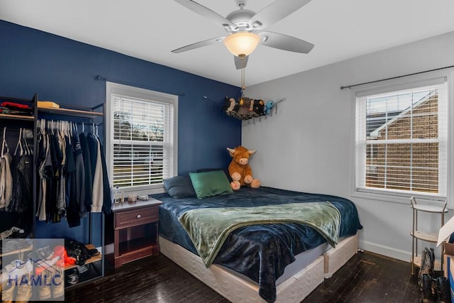 bedroom with a ceiling fan, a closet, baseboards, and hardwood / wood-style flooring