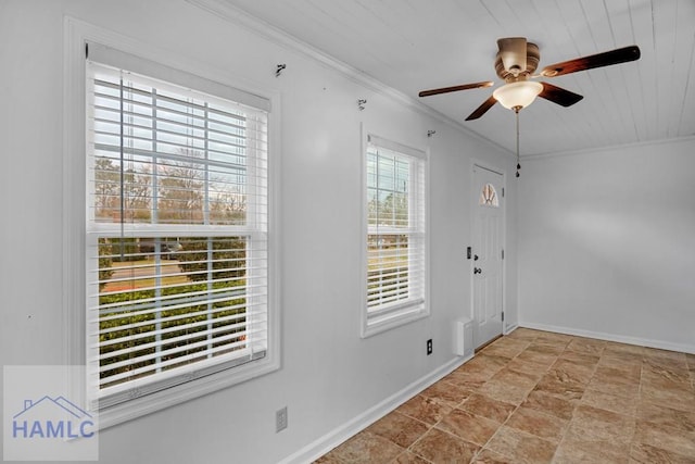 foyer entrance with baseboards, ornamental molding, and ceiling fan