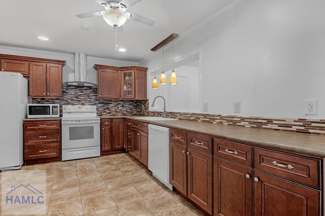 kitchen featuring tasteful backsplash, ornamental molding, a sink, white appliances, and wall chimney exhaust hood