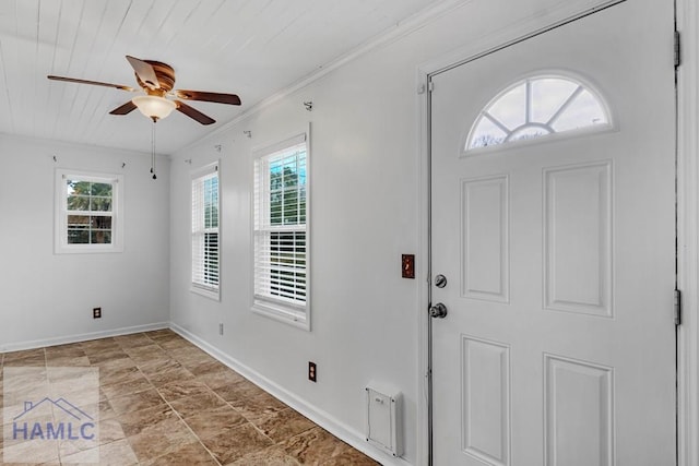 entrance foyer featuring wooden ceiling, baseboards, ornamental molding, and ceiling fan