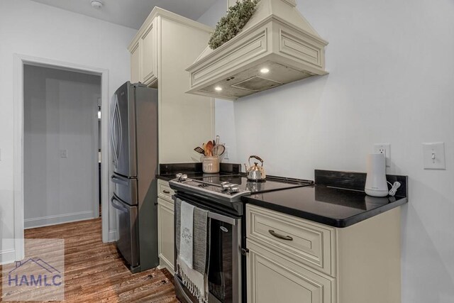 kitchen with dark countertops, cream cabinets, and stainless steel appliances