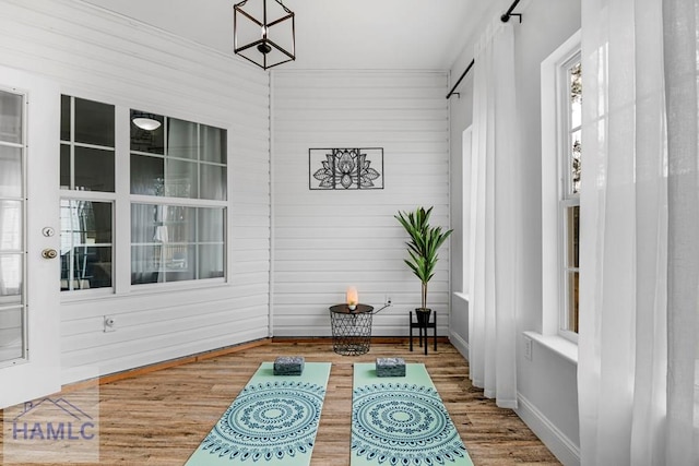 interior space featuring baseboards and wood finished floors