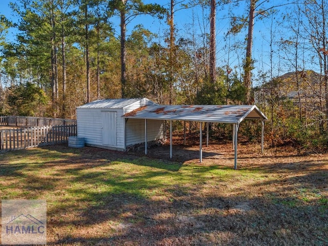 view of shed featuring fence and a detached carport