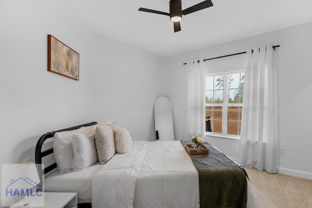 carpeted bedroom featuring ceiling fan and baseboards