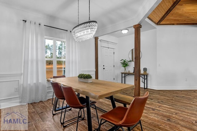 dining area with a notable chandelier, baseboards, dark wood-style floors, decorative columns, and crown molding