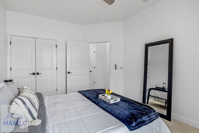 bedroom with a ceiling fan, a closet, light colored carpet, and baseboards