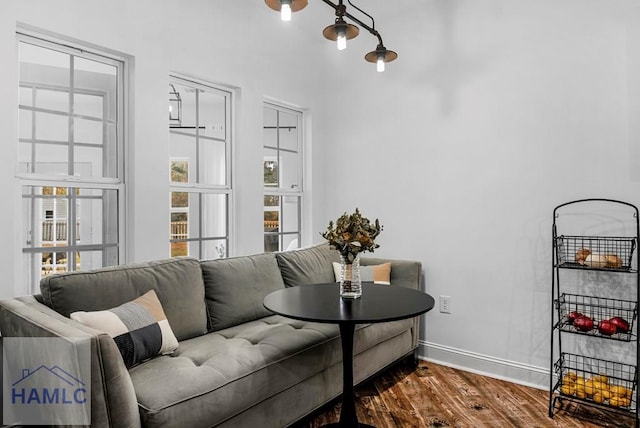 living room featuring baseboards and dark wood finished floors