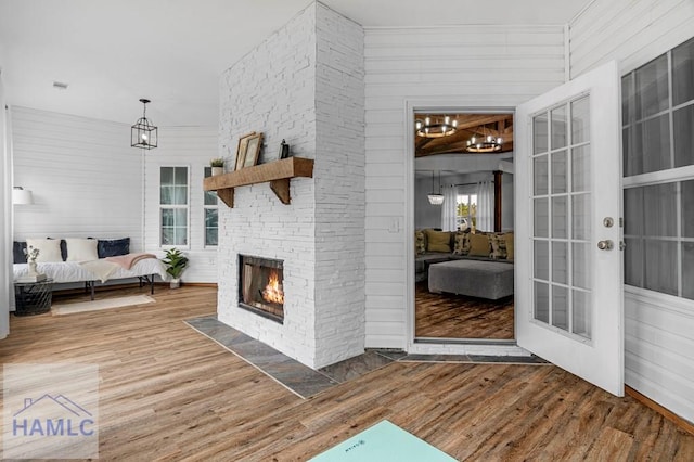 interior space featuring a stone fireplace and a wooden deck