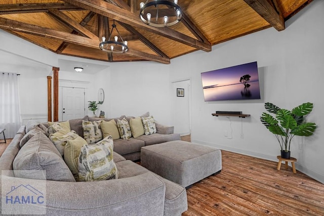 living room featuring wood finished floors, wood ceiling, baseboards, beam ceiling, and an inviting chandelier