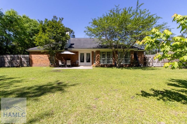 435 Arlington Dr, Hinesville, GA 31313 - rear view of house featuring a patio area, french doors, fence, and a lawn