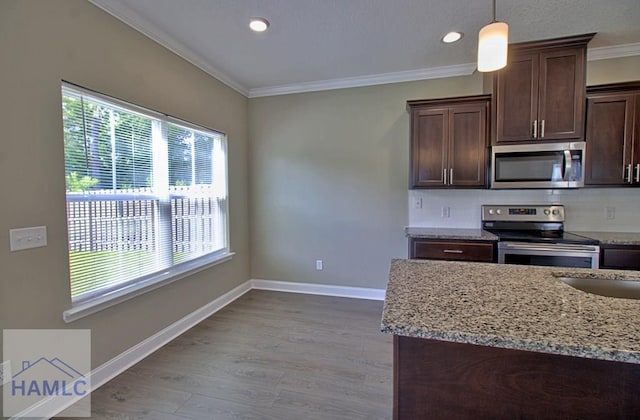 587 Fairview Cir, Hinesville, GA 31313 - kitchen with appliances with stainless steel finishes, ornamental molding, light stone countertops, wood finished floors, and dark brown cabinets