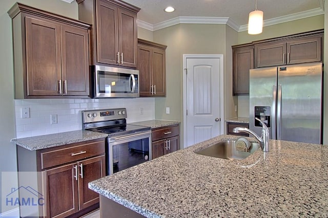 587 Fairview Cir, Hinesville, GA 31313 - kitchen featuring stainless steel appliances, a sink, light stone countertops, ornamental molding, and recessed lighting