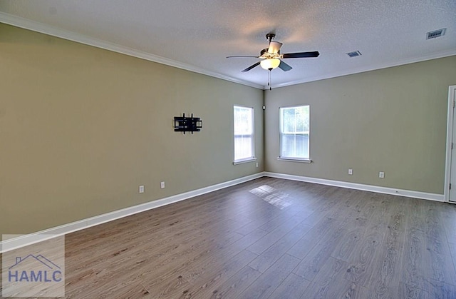 587 Fairview Cir, Hinesville, GA 31313 - spare room featuring dark wood-style flooring, ceiling fan, baseboards, ornamental molding, and a textured ceiling