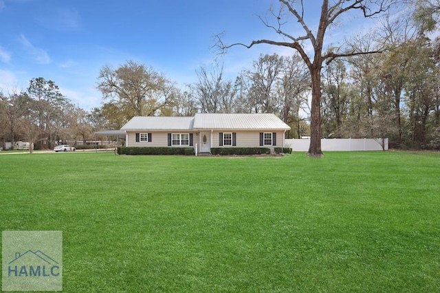 single story home featuring metal roof, a front lawn, and fence