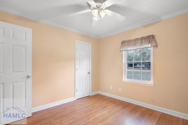 unfurnished bedroom featuring ornamental molding, light wood-type flooring, and baseboards