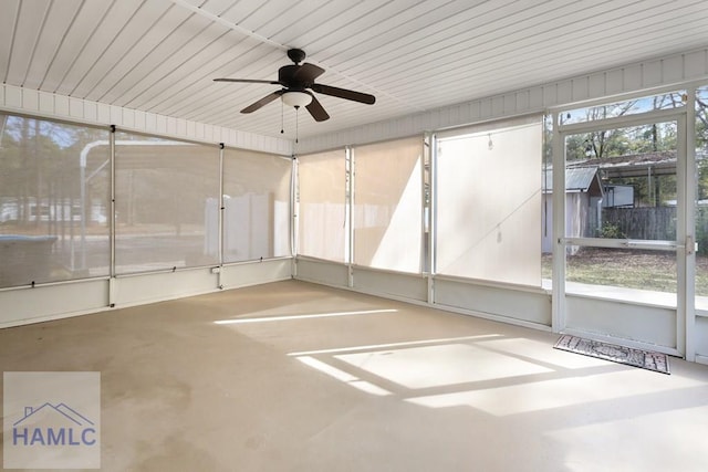 unfurnished sunroom with a ceiling fan