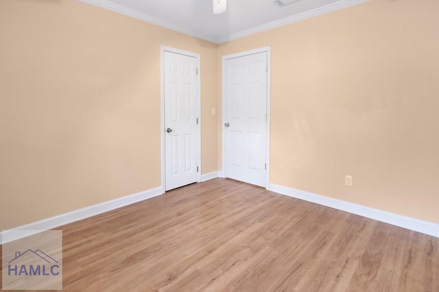 spare room with ornamental molding and baseboards