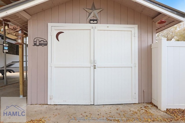 view of shed featuring fence