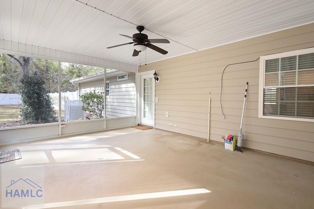 unfurnished sunroom with ceiling fan